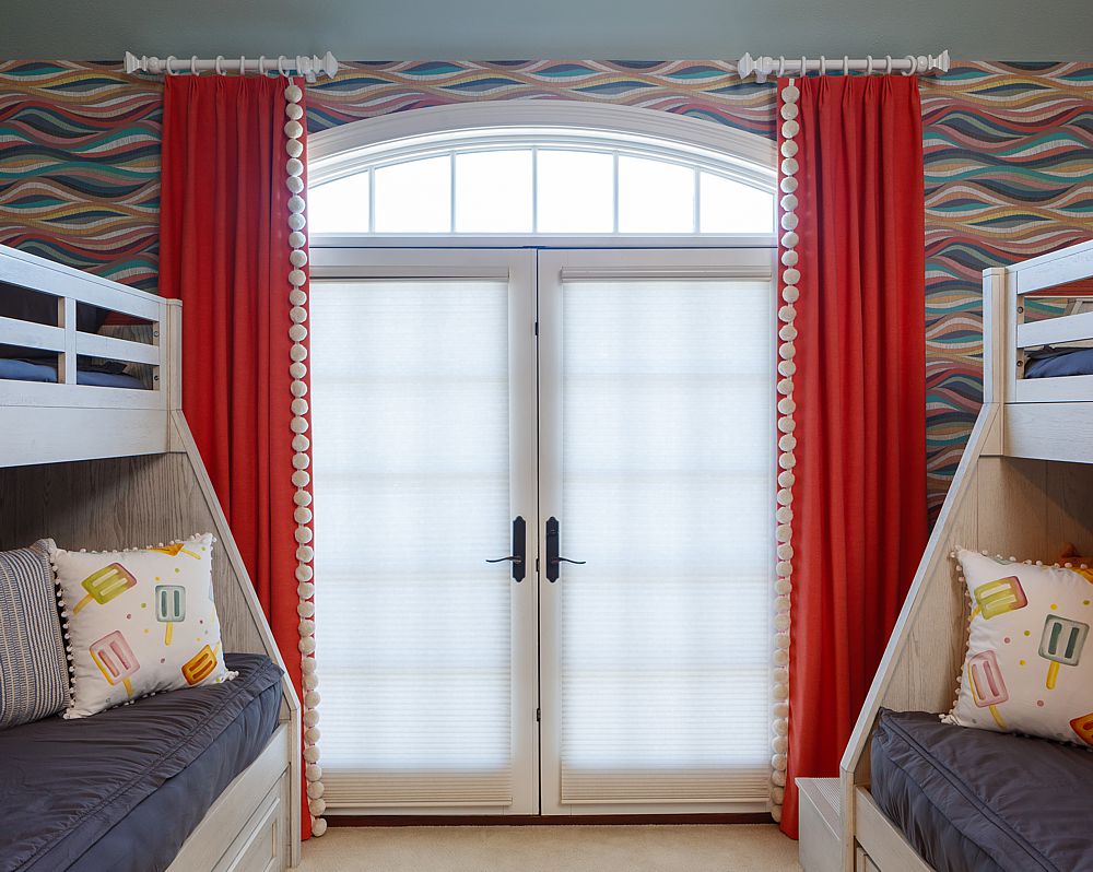 This bunk room shows how a jazzy wallpaper combined with gorgeous drapes make the room extra special for grandkids.